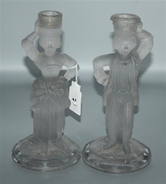 A pair of glass candlestick figures and a decanter